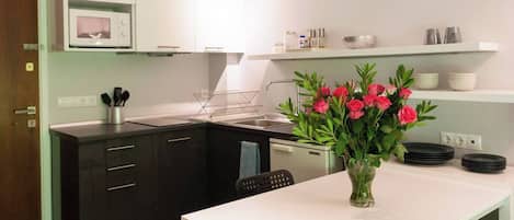 Fridge, microwave, coffee/tea maker, cookware/dishes/utensils