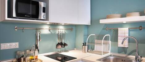 Fridge, microwave, coffee/tea maker, cookware/dishes/utensils