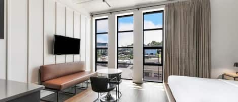 Sip morning coffee by tall windows in a bright suite.