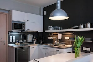 Fridge, microwave, coffee/tea maker, cookware/dishes/utensils