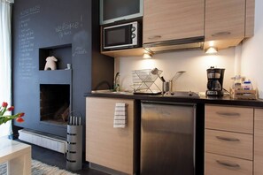 Fridge, microwave, coffee/tea maker, cookware/dishes/utensils