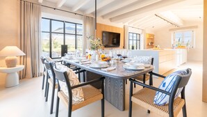 A modern dining area with a large table, chairs, and a television. - Country House 'Agata' with Private Pool, Wi-Fi and Air Conditioning (Illes Balears)