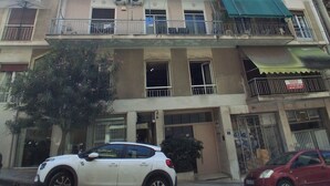 A multi-story building with balconies, air conditioning units, and a 'For Sale' sign. - Penelope's Charming 2-BR Apt in Athens (Athens)