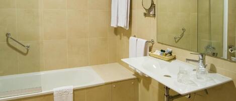 A bathroom with a bathtub, a sink, and a shower.