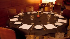 A round dining table set for a meal with chairs around it. - Snö La Corza Blanca (Brañavieja)