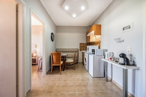 Family Quadruple Room, Balcony, City View | Private kitchen | Full-size fridge, microwave, stovetop, espresso maker