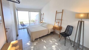 A bedroom with a bed, bedside table, chair, and a desk. - House with splendid view - Grosseto-Prugna (Grosseto-Prugna)