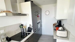 A modern kitchen with a stainless steel range hood, a built-in oven, a coffee maker, and a toaster. - House with splendid view - Grosseto-Prugna (Grosseto-Prugna)