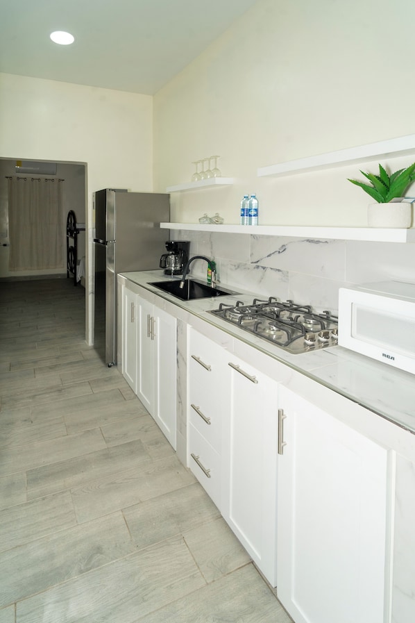 Fridge, microwave, coffee/tea maker, cookware/dishes/utensils