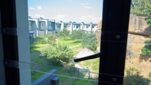 A view of a residential area with modern houses and a grassy courtyard.