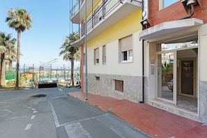 A building with a balcony, a door, and a window.