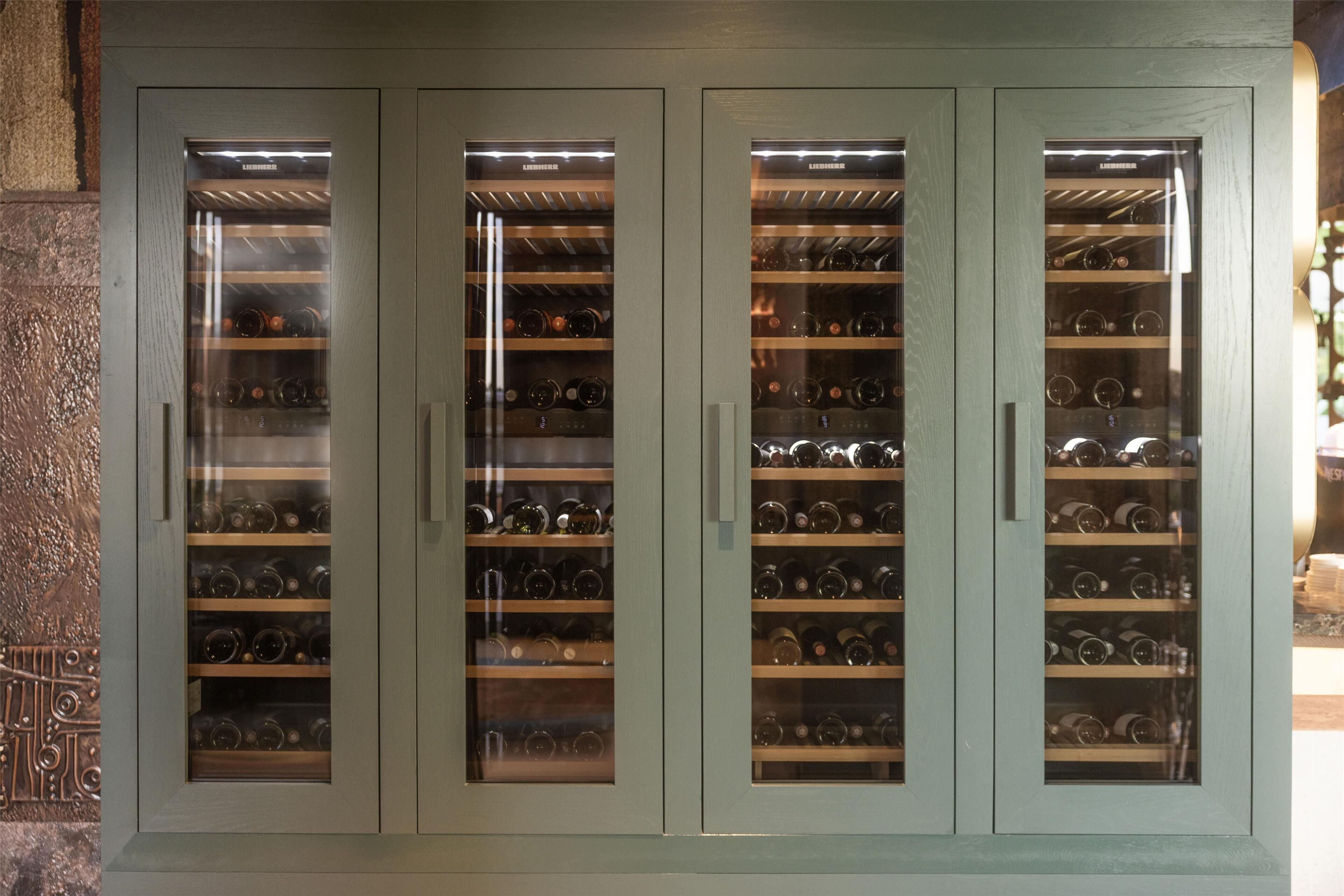 A wine cabinet with multiple shelves and glass doors.