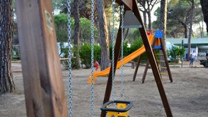 Un parque infantil con columpios y un tobogán.