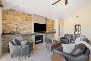 Smart TV, fireplace, books, stereo