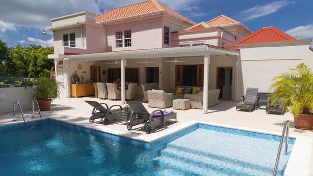 A poolside area with lounge chairs and a covered seating area. - Jack's Place - by Zenbreak (Mullins)