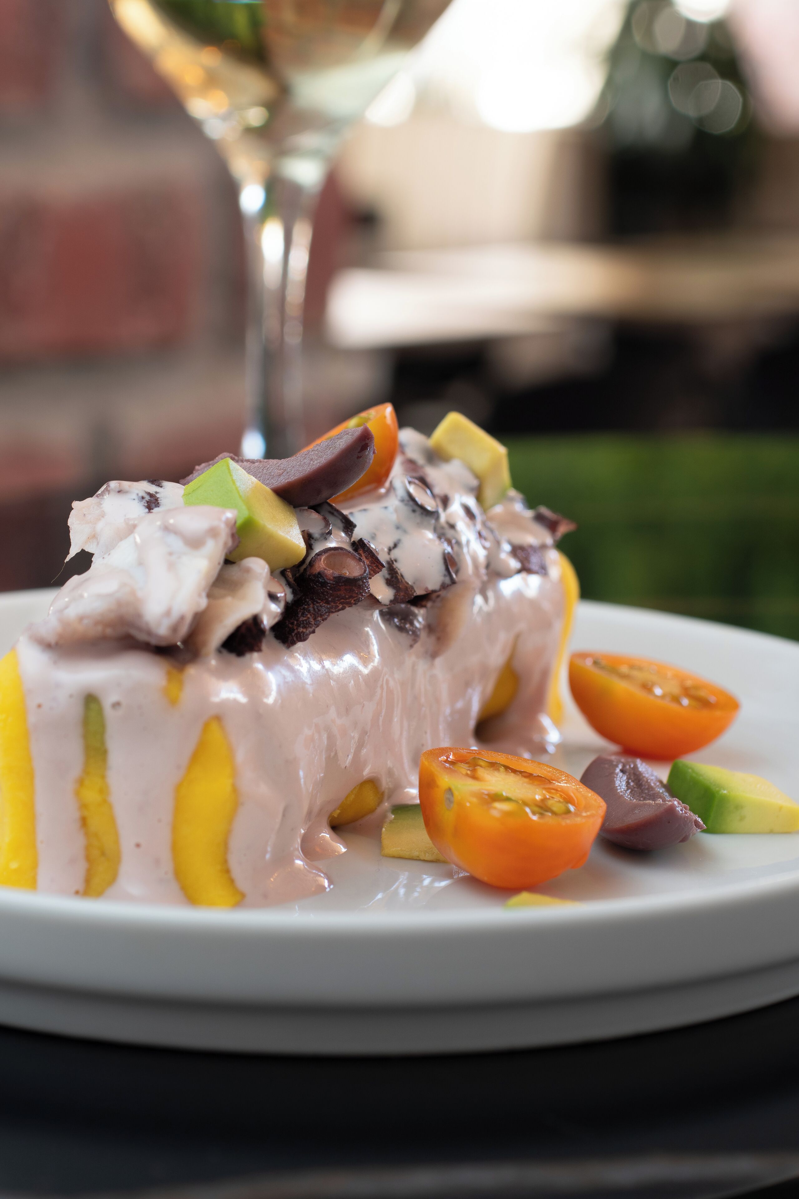 A dessert with various fruits and chocolate pieces on a plate.