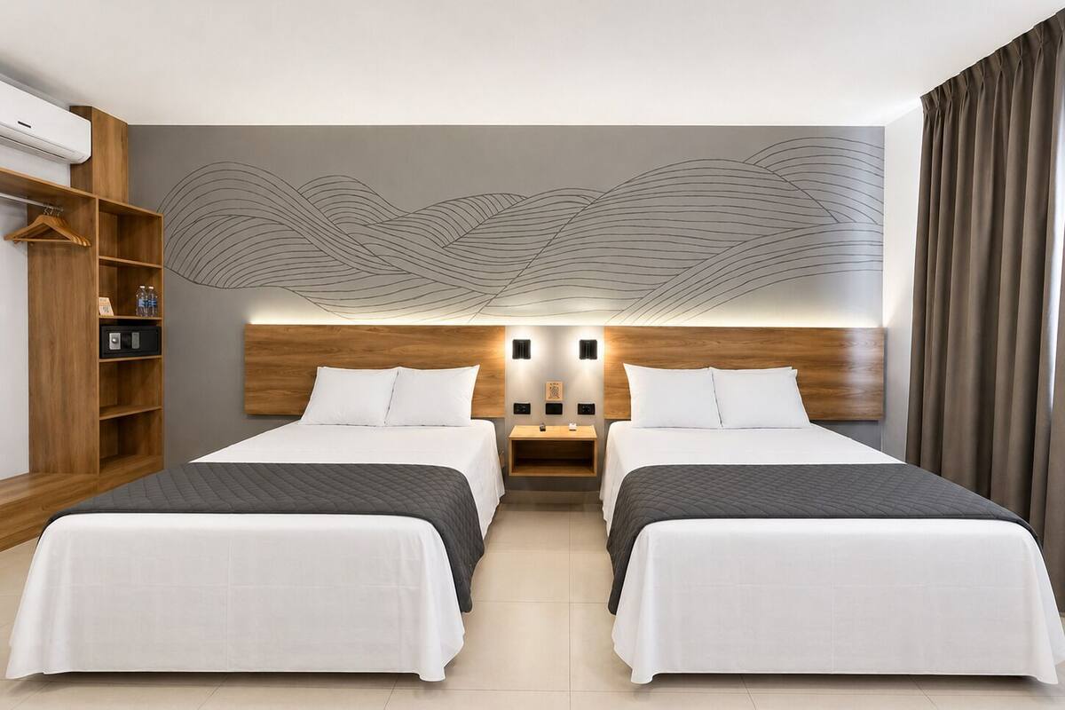 A hotel room with two beds, a wooden headboard, a wall-mounted shelf, and a large abstract mural.