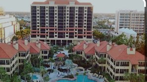 A hotel with multiple buildings, a central courtyard with a swimming pool, and surrounding greenery. - Eagle's Nest Gulf Front Unit, Closest to the Beach - Platinum Week 11 (Marco Island)