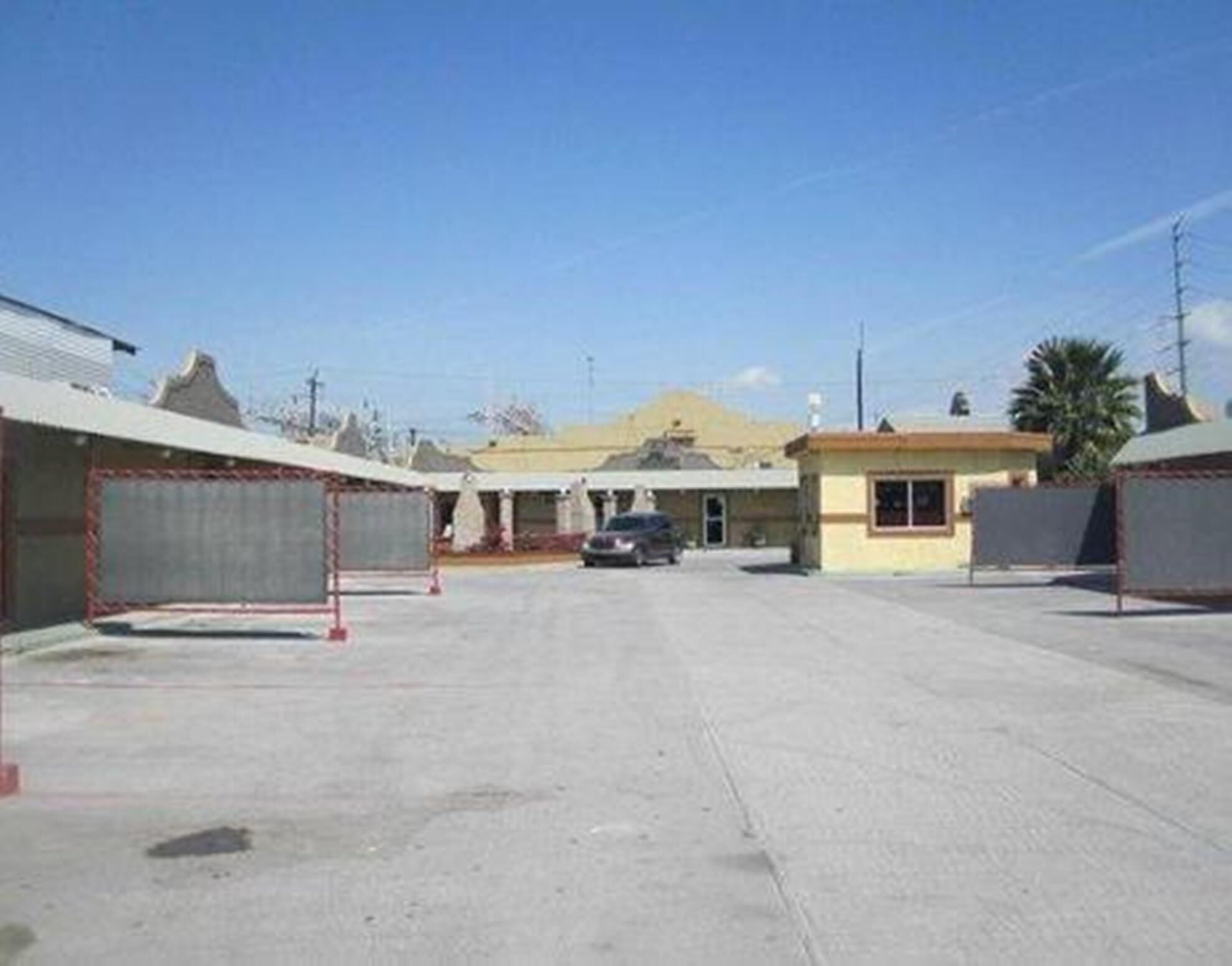 A parking lot with a building in the background.