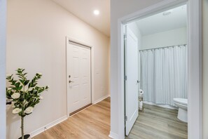 A hallway with a door and a potted plant. - Water Oaks Retreat Charming 2-bedroom house in Laurel Hill (Laurel Hill)