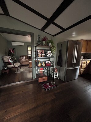 A modern kitchen with a stainless steel refrigerator, wooden cabinets, and a built-in oven. - Feisty Ranch Farm Retreat - Private and charming 2-bedroom on 15 acres (Aquone)