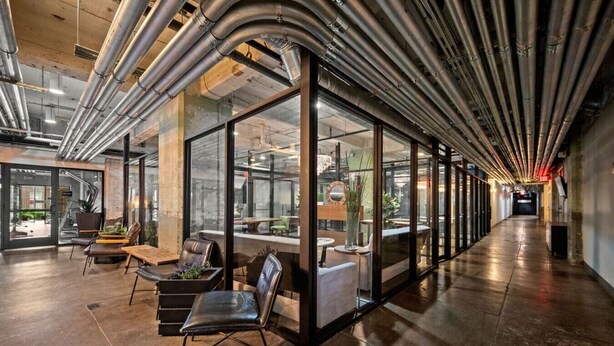 A modern interior with glass partitions, leather seating, and exposed ductwork. - Rodeo Room Downtown Loft | Skyline View, Pool ,Gym & Free Valet Parking (Dallas)