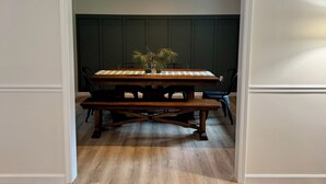A dining area with a wooden table, chairs, and a bench.