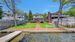 A residential area with a clear swimming pool, a wooden deck, and a grassy lawn. - Lakefront-Fish&Kayak-FirePit-hottub-walk to bars (Lake Harmony)