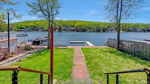 A lakeside view with a dock, grassy area, and a pathway leading to the water. - Lakefront-Fish&Kayak-FirePit-hottub-walk to bars (Lake Harmony)