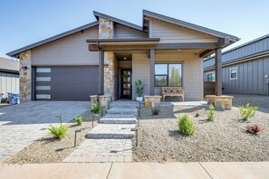 A modern two-story house with a stone accent wall, a covered front porch, and a driveway leading to a garage. - 3 Mi to Dtwn Flagstaff: Family Retreat w/ Patio (Flagstaff)