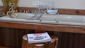 A bathroom with a wooden vanity, a sink, and a mirror. There is a sign on the wall that reads "it's always starry night's in here." - Sironka Cabin Getaway in Ole Lekurruki, Naromoru. (Mureru Farm)