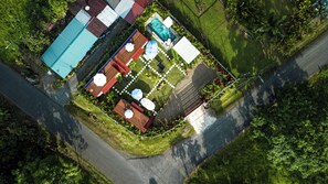 Vista aérea de un área residencial con piscina, varios edificios y una carretera.