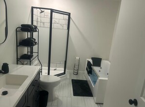 Jetted tub, hair dryer, towels, soap