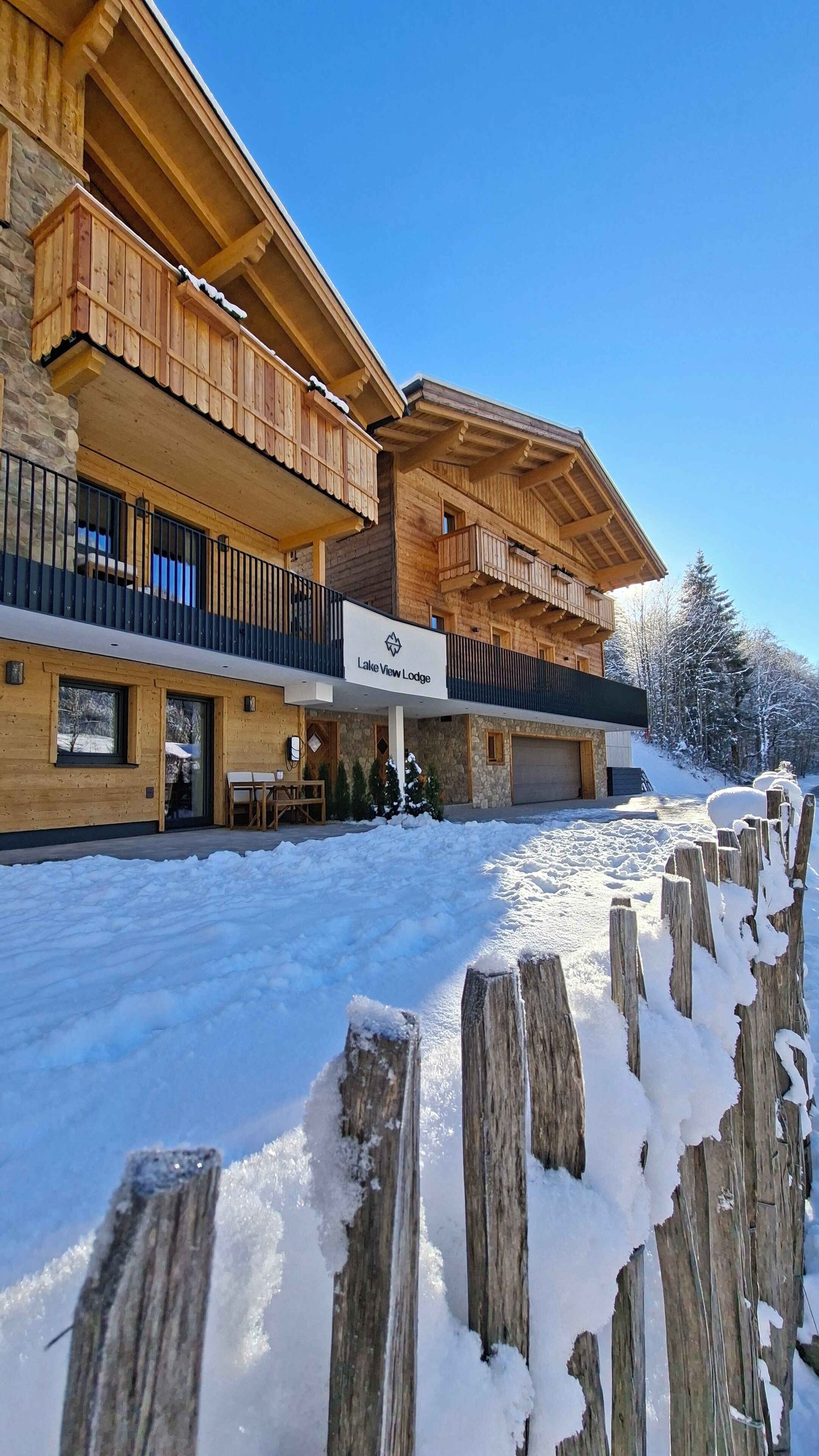 A two-story lodge with a sign reading "Lake View Lodge."