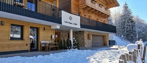 A two-story lodge with a sign reading "Lake View Lodge."