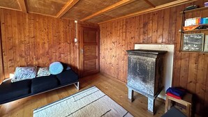 A wooden-paneled room with a sofa, a small table, and a cabinet.