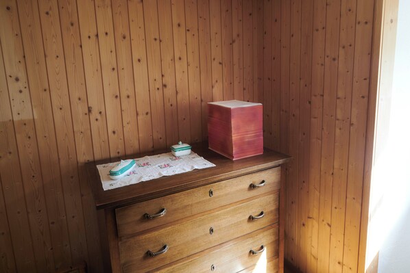 A wooden dresser with drawers and a box on top.
