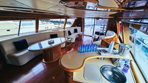 A luxurious interior with a seating area, a bar, and a sink. - Riviera Leisure Yachts Dubai  (Dubai)