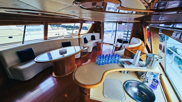 A luxurious interior with a seating area, a bar, and a sink.