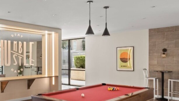 A pool table in a modern room with a large mirror and pendant lights. - Chic 2-bedroom apartment with AC, WiFi in wonderful Los Angeles (Los Angeles)