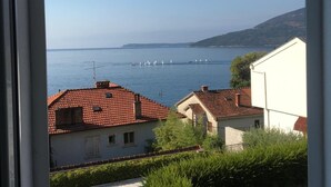 A coastal view with houses and a clear sky.
