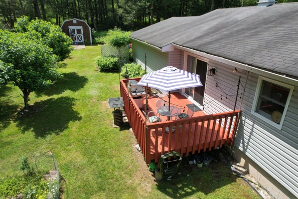 A house with a fenced backyard, a deck with outdoor furniture, and a garage. - Catskills Getaway: 3BR Retreat w/ Media Room, Near Casino, Bethel Woods & More! (Glen Wild)