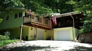 A two-story house with a balcony, a garage, and a covered porch.