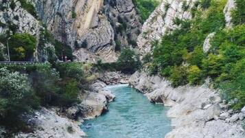 A river flowing through a rocky gorge with steep cliffs on either side.