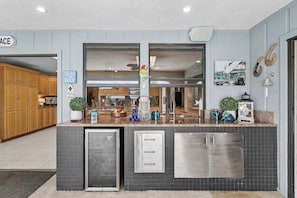 A kitchen with a built-in refrigerator, a sink, and a window.