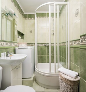 A bathroom with a shower, sink, and toilet.