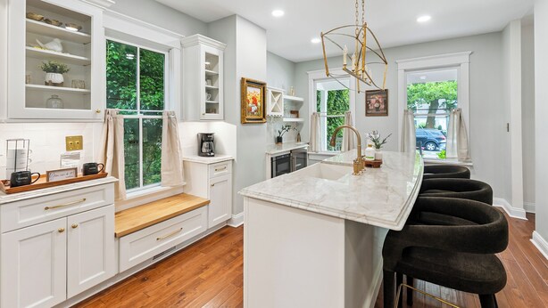 A modern kitchen with white cabinetry, a marble island, and a built-in bar area. - Charming 6-bedroom house with AC, WiFi in wonderful West Cape May (West Cape May)