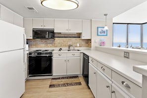 Fridge, microwave, oven, stovetop - Sea Pointe 702: End unit with endless shoreline views, overlooking sought-after Cherry Grove Point. (North Myrtle Beach)