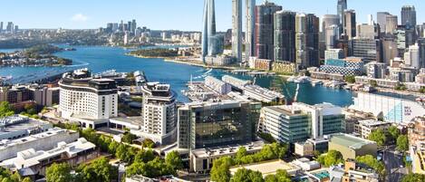 A cityscape with modern buildings, a waterfront, and a prominent museum.