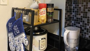 A kitchen with a coffee-themed decor, including a wall sign, a coffee machine, and various coffee-related items on the counter. - Fabulous 2-bedroom condo unit in Quezon (Quezon)